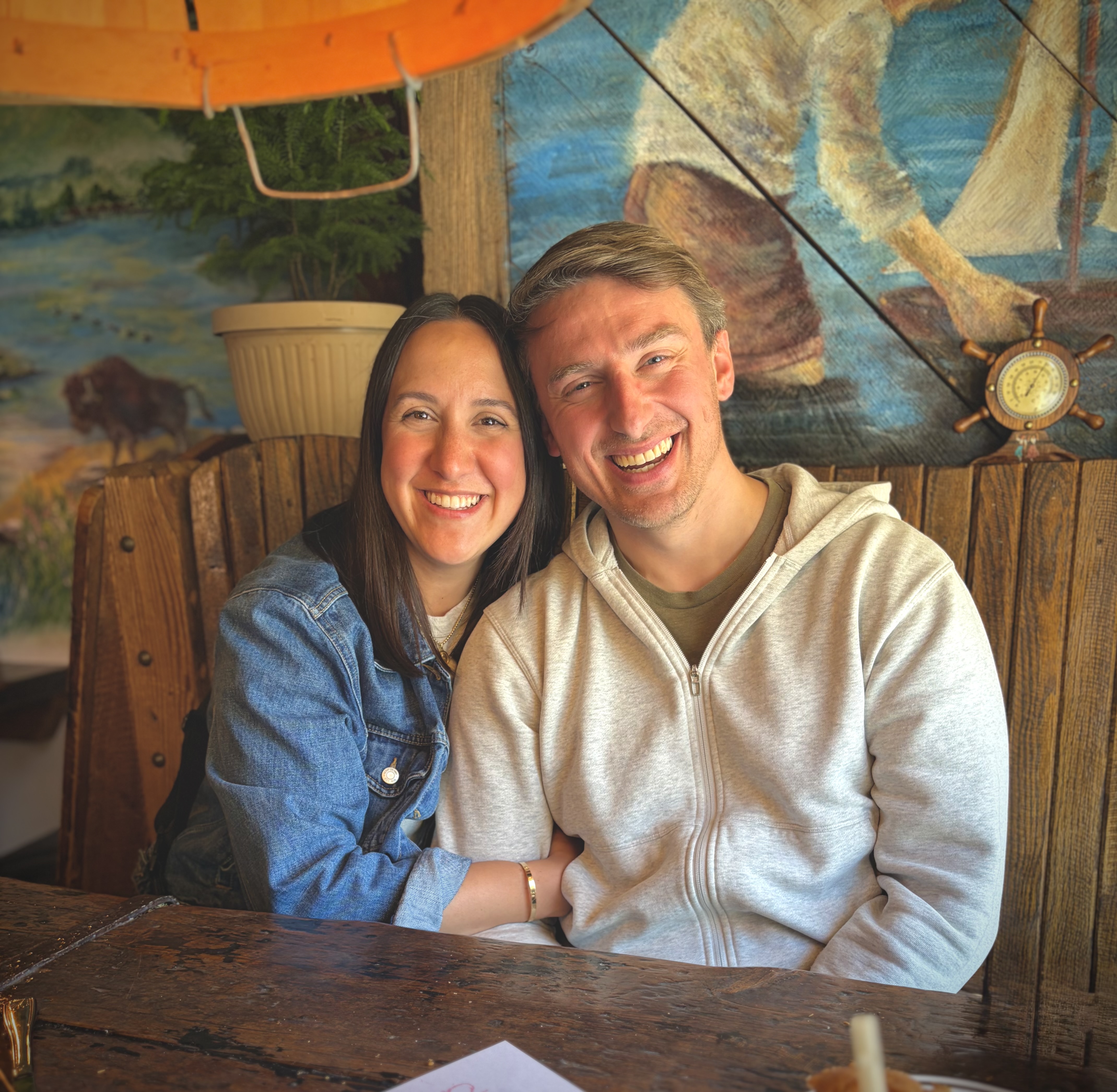 Ali and Josh, founders of The FI Couple and Dollar FI, smiling together.